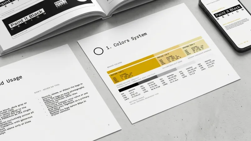 Brand book Paint It Black aperto sulla pagina del sistema colori, accanto a uno smartphone